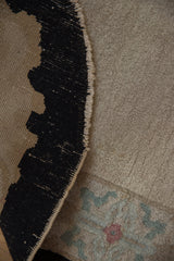 Detail of the vintage Fette-Li rug's hand-knotted back and plush beige pile.