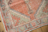 Distressed Oushak rug detail, pale burnt orange, sea foam green, and aubergine, showing knot wear and foundation.