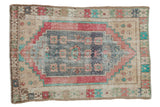 Distressed vintage Oushak rug with faded blue medallion, rose, and sand patterns, 3'3