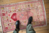 Faded floral motifs with playful colors and worn texture on a distressed Oushak rug.