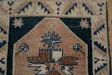 Geometric contour floral motif on a distressed Oushak rug in beige, copper, and dusty teal.