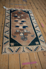 Distressed texture of geometric floral motifs in copper, beige, and dusty cobalt blue.