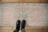 Vintage distressed Oushak rug runner showing worn pile, muted tangerine, seafoam, and ivory colors.