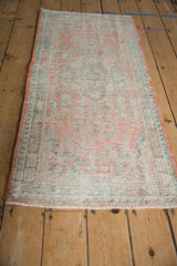 Pale tangerine side selvage and distressed pile of a vintage Oushak rug runner.
