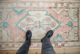 Overhead view showing the scale and soft, distressed texture of a vintage Turkish Oushak rug.