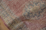 Distressed hand-knotted pile of the Oushak runner, featuring faded blush, cobalt blue, and beige Rococo motifs.