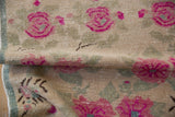 Folded vintage distressed Oushak runner, showing fuchsia floral motifs and even wear.