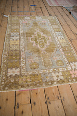 Vintage distressed Oushak rug corner, olive green spandrel, oversized geometric floral border.