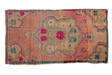Vintage Distressed Oushak runner, central floral medallion, vibrant fuchsia, blush, and muted green.