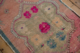 Distressed Turkish Oushak runner, fuchsia and blush medallion pattern with a soft, worn pile.
