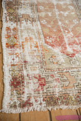 Distressed Oushak rug detail with visible foundation and burnt orange hues.