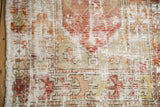 Distressed vintage Oushak rug: worn wool-cotton pile, visible foundation, faded floral motifs.