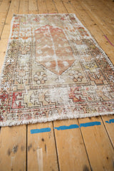 Vintage Distressed Oushak rug with worn pile, exposed foundation, and cream fringe.