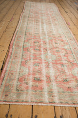 Distressed blush, mint green, and ivory pile with a faded Herati pattern on the vintage Oushak runner.