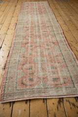 Distressed vintage Oushak runner texture, showing mostly even wear, blush and mint Herati floral motifs.