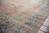 Distressed Oushak rug showing worn pile, visible foundation, and faded floral motifs in blue, red, and ivory.