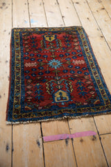 Finned floral medallion, sapphire blue vinery, and ornate blossoms on deeply saturated cherry red Lilihan rug.