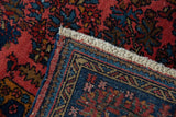 Close-up of a vintage rug corner showing the secured side cord and neatly added short fringe.