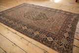 Farahan Sarouk antique rug lower corner: detailed floral border, vinery, and even wear.