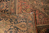 Antique Farahan Sarouk rug's folded corner, displaying hand-knotted foundation, worn floral patterns, and intact selvage.