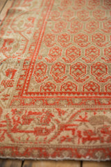 Distressed Malayer rug detail: worn pile texture with cinnabar boteh pattern.