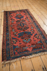 Vintage Mehriban rug with dusty pink field, teal palmettes, vine border, and uneven fringe.