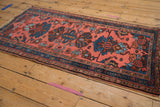 Teal palmette and stylized floral motifs on the dusty pink field of the Mehriban rug.