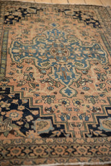 Nuanced floral blossoms on dusty blush field of an antique Farahan Sarouk rug, with even wear.