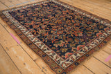 Kurdish Bijar rug corner, floral palmettes, serrated leaves, in cobalt, madder, and ivory.