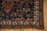 Antique Kurdish Bijar rug corner with cobalt blue field, palmettes, and layered borders.