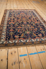 Antique Kurdish Bijar rug: ivory border, cobalt blue field with madder root red patterns.