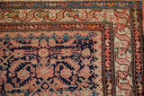 Vintage Hamadan rug corner: navy Herati field, patterned ivory, ruby red borders, knot wear.