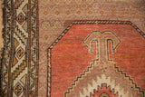 Vintage Hamadan rug detail: serrated leaf main border and stepped coral medallion with ivory and sage.