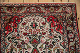Intricate floral border and original side cord selvage on a vintage Persian Dargezine rug.