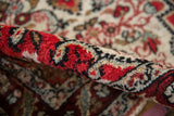 Rolled edge of a vintage Dargezine rug showing the dense, even hand-knotted wool pile.
