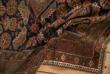 Folded antique Belouch rug with Herati inspired navy, rust, ivory geometric patterns and border.