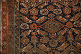 Serrated geometric Herati motif, navy blue and rust tones, worn pile of antique Belouch rug.
