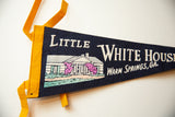 Vintage felt pennant, yellow binding, navy blue, and Little White House graphic.