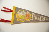 Vintage Sault Ste Marie felt flag with red ribbons, yellow stitched trim, and Soo Locks graphic.