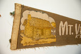 The worn stitched binding and log cabin graphic on a vintage felt Kentucky pennant.