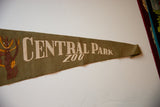 Cream 'Central Park Zoo' lettering on olive green felt pennant tip.