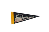 A vintage Roadside America felt flag in black and yellow with a graphic of the miniature village.