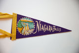 A vintage purple felt pennant for Niagara Falls with yellow ties and graphic.
