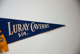 Off-white serif lettering for Luray Caverns on the vintage blue felt pennant.