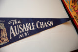 Detail of the graphic lettering and felt texture on the blue vintage Ausable Chasm pennant.