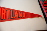 Red felt vintage Portland Oregon pennant with orange 'RTLAND' text and pointed tip.