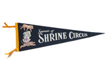 Vintage black felt Shrine Circus pennant with graphics of a clown, lion, and tiger.