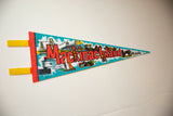 Felt pennant displaying 'Mackinac Island' with varied retro travel graphics.