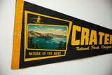 Black felt vintage Crater Lake flag, featuring bold yellow text and Wizard Island postcard.