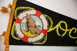 Vintage Oceanside Oregon felt pennant with yellow binding, ties, and seal graphic.